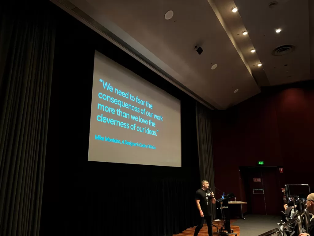 A screen from Niall Holder's keynote: "We need to fear the consequences of our work more than we love the cleverness of our ideas." It is a quote by Mike Monteiro from A Designer's Code of Ethics.